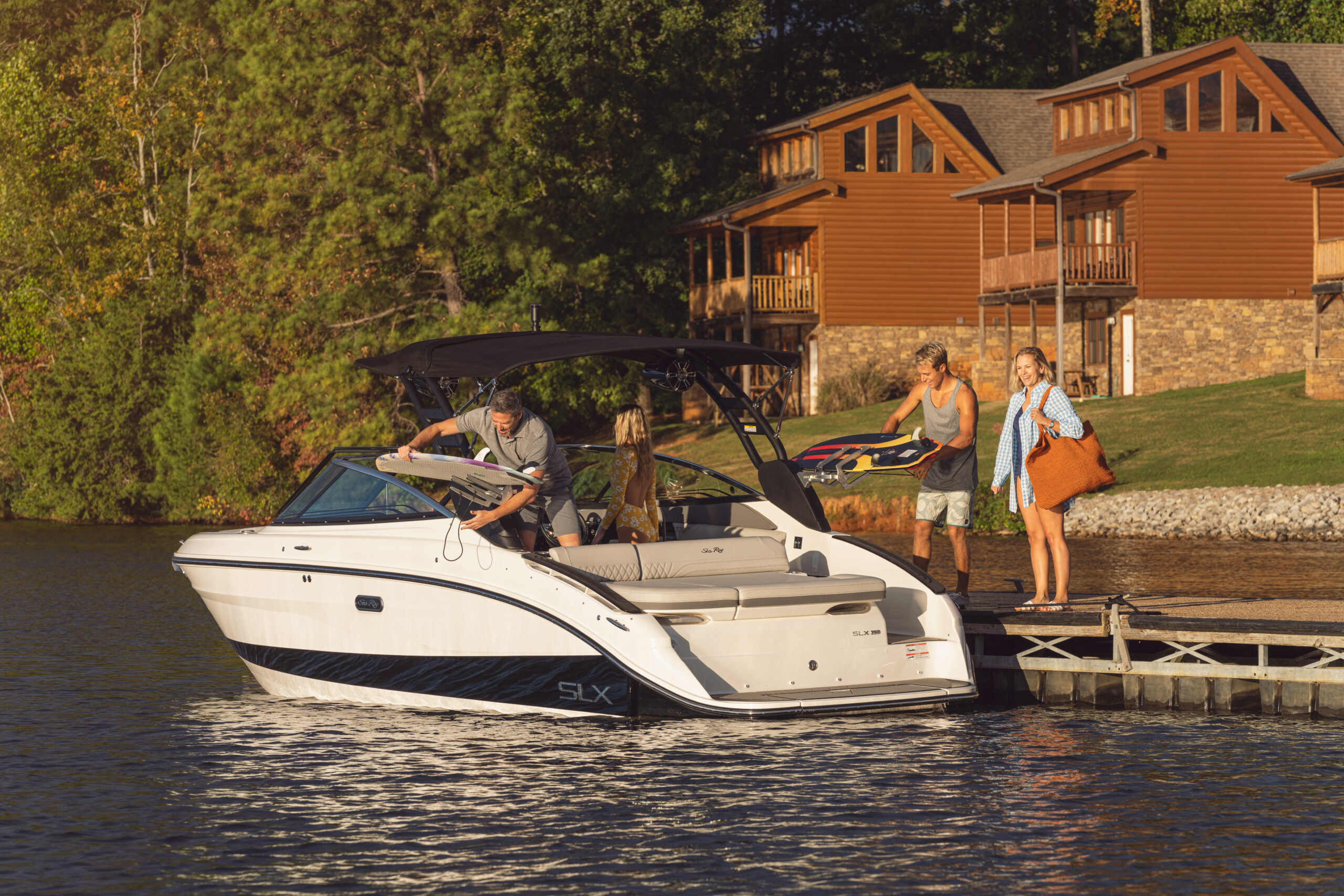 Family boarding an SLX 260 Surf